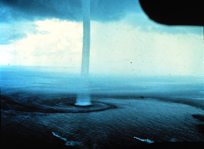 Waterspout with banded inflow off the Florida Keys, 1969-09-10, credit Joseph Golden, courtesy NOAA. Notice the flares indicating that the prevailing surface winds are not part of the inflow.