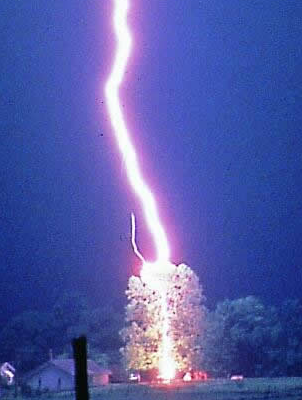 Lightning. Notice the small violet corona discharge. Courtesy Johnny Autery.